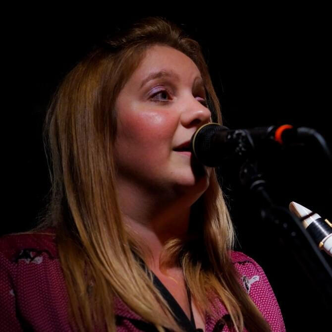 Natasha singing on stage in Brazil. She is a singing teacher, saxophone tutor and music mentor in West Yorkshire, UK